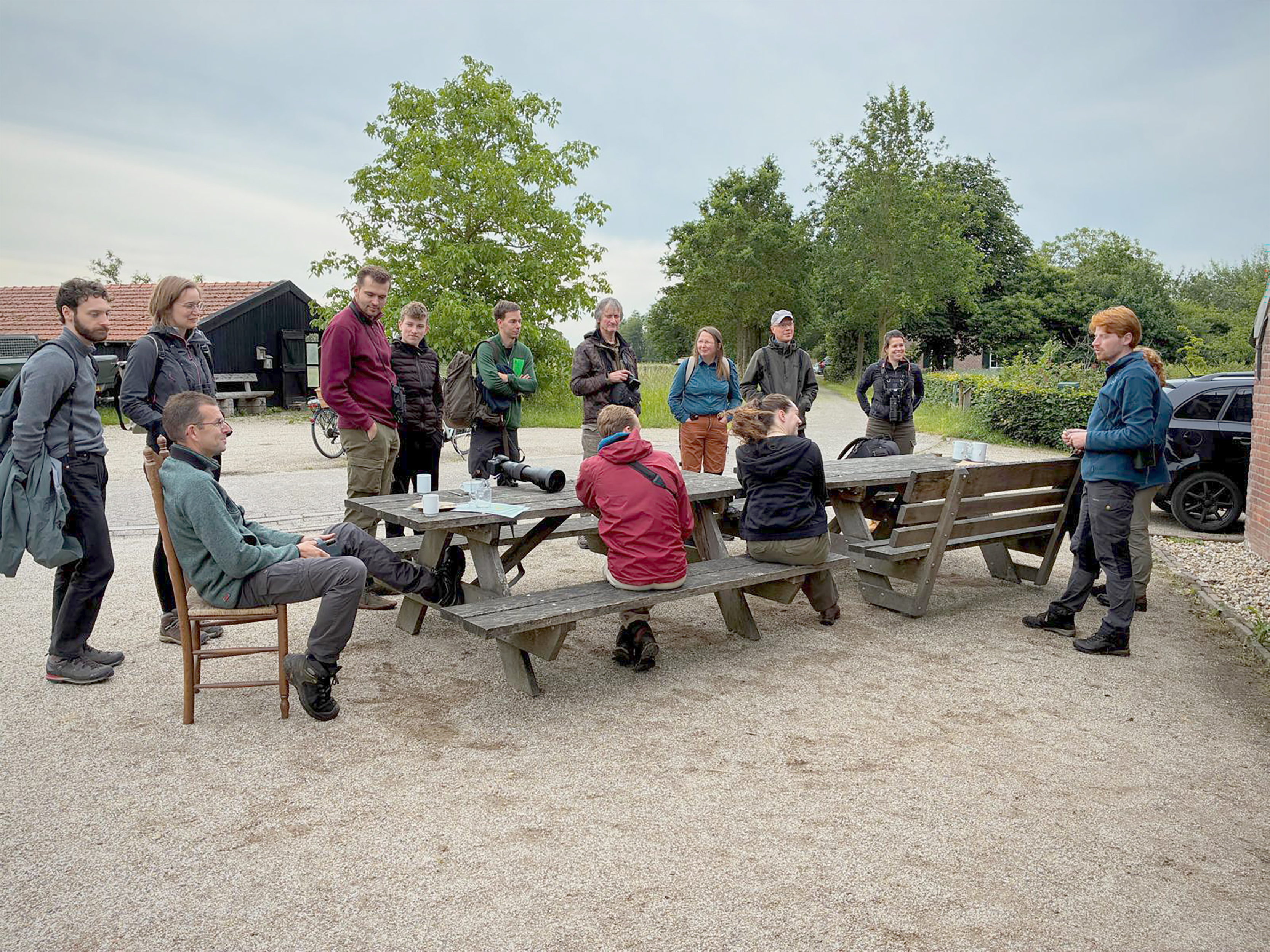 Deelnemers luisteren na het ontbijt naar de uitleg van het dagprogramma